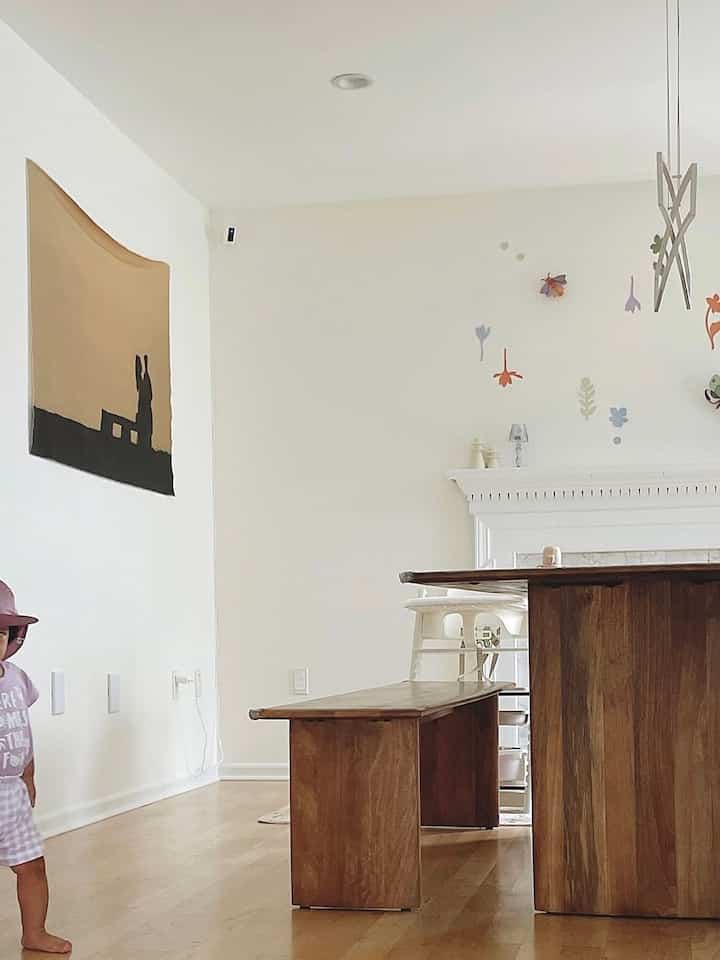 Natural wood-toned dining room featuring a solid wood dining table and bench with a young child, creating a warm atmosphere