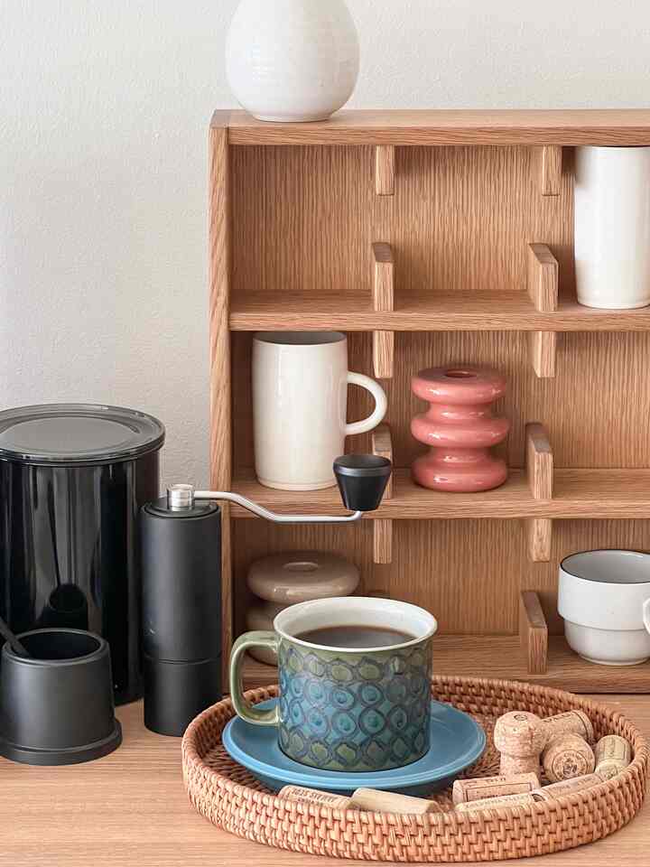 Wood tone kitchen space featuring coffee grinder and mug, creating a cozy home cafe atmosphere