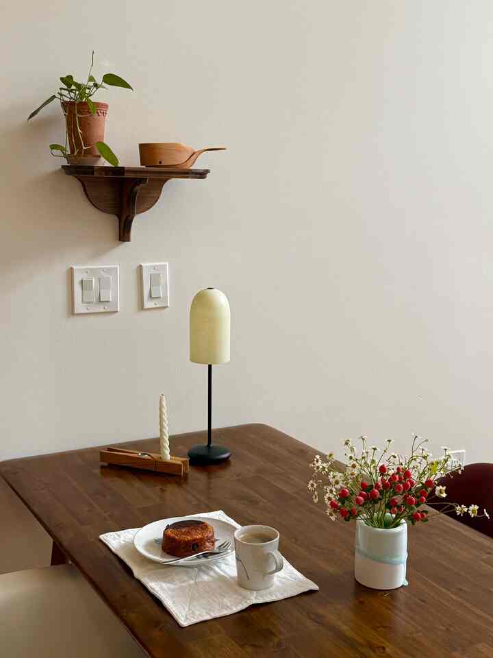 Mid afternoon snack time. A cup of coffee and a chocolate croissant 🥐☕️

#cozy #diningtable #diningchair #diningzone #tablelamp #candle #shelf #woodenshelf #woodshelf #aesthetic #snacktime #timeforcoffee