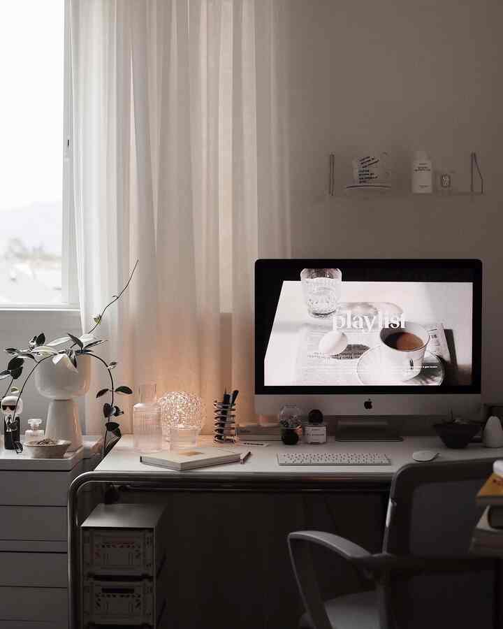 White and beige toned home office with iMac and plant, creating a calm and minimalist workspace