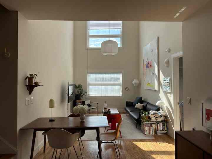 Natural color living and dining room featuring modern furniture and wall art with cozy atmosphere