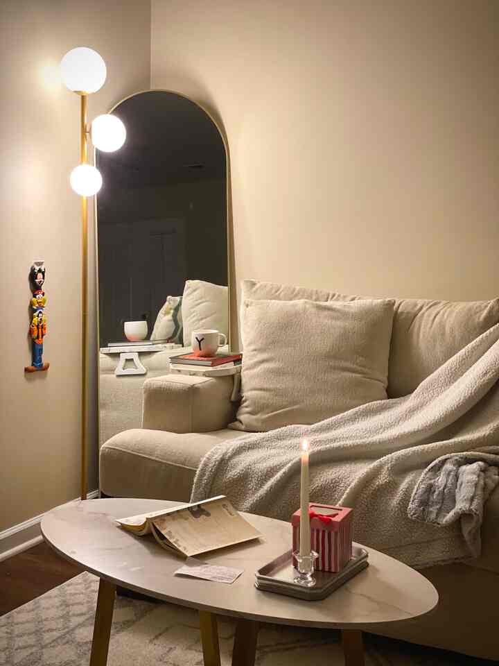 Warm ivory and brown toned living room featuring beige sofa and marble coffee table with cozy ambiance