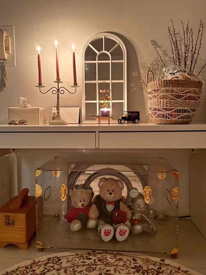 Beige and white tone entrance space featuring candle holder and teddy bears creating warm ambience