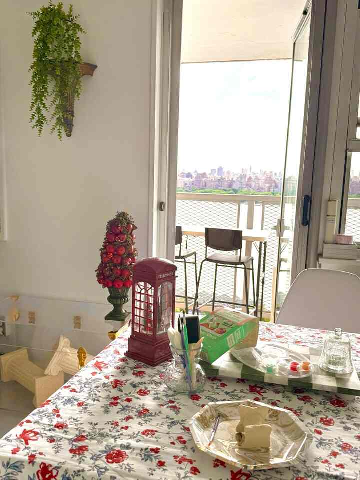 Red and white toned dining room featuring a floral tablecloth and candle decorations with a warm, cozy atmosphere
