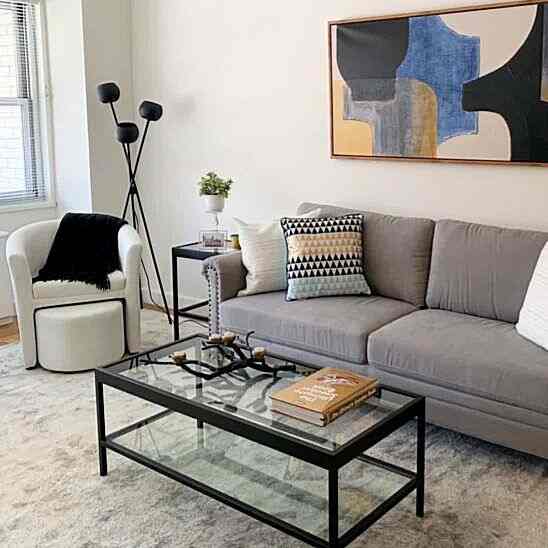 Gray sofa and black floor lamp in a simple modern-toned living room space