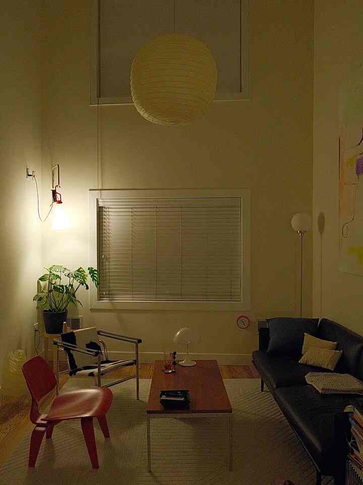 Cozy living room with white walls, warm lighting, and mid-century modern furniture arrangement