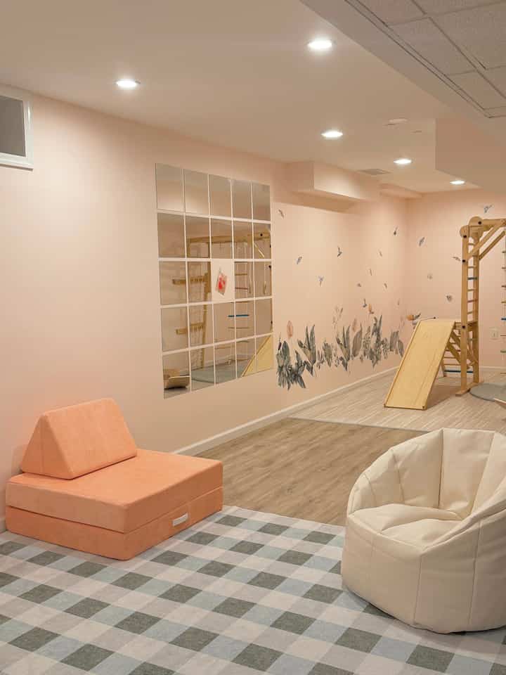 Soft beige and orange toned kids' room featuring a bean bag chair and wooden play structure creating a cozy atmosphere