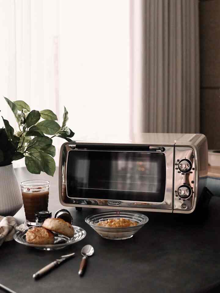 Natural toned kitchen space featuring transparent bowls and cutlery on a simple home cafe style dining table