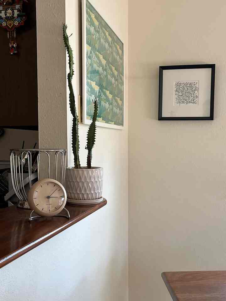 Natural-toned space with light wood counter and framed pictures on the wall