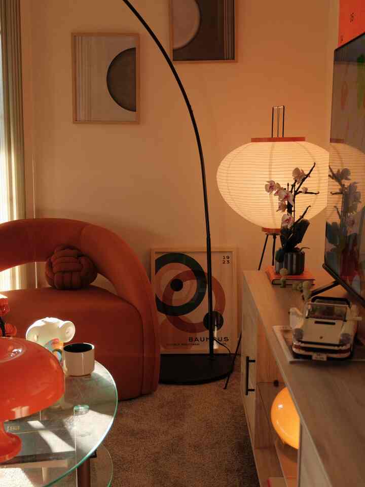 Orange and beige toned living room featuring mid-century modern furniture and warm lighting for a cozy atmosphere