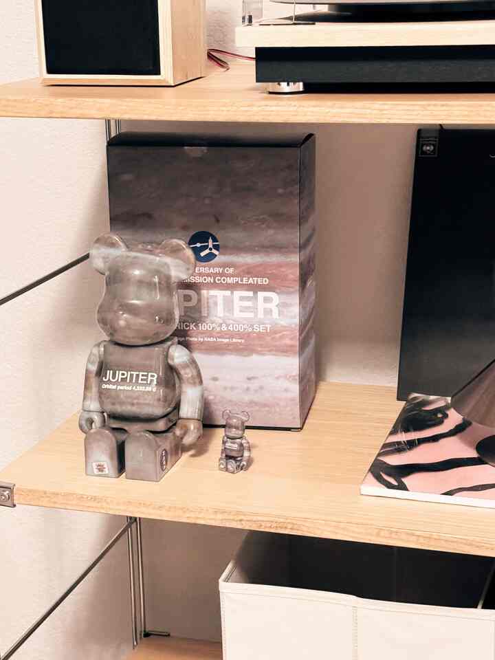 Natural and simple home gallery featuring a brown wood shelf with Jupiter Bearbrick art toys and storage boxes