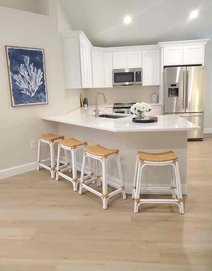 The white cabinetry and quartz countertops create a fresh, modern look. #BrightKitchen #WhiteCabinets #ModernHome #Framedposter