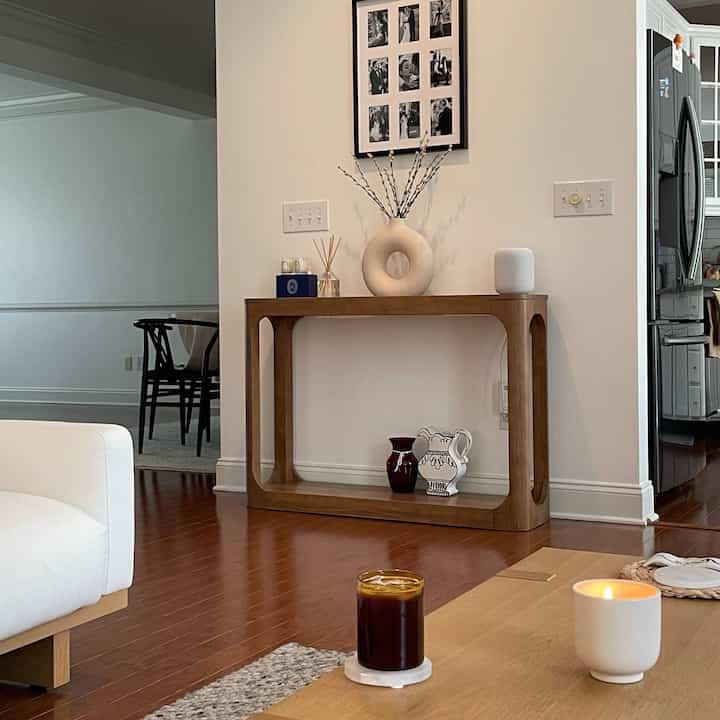 Minimal Japandi living room with white walls and brown wooden furniture creating a natural, calm atmosphere