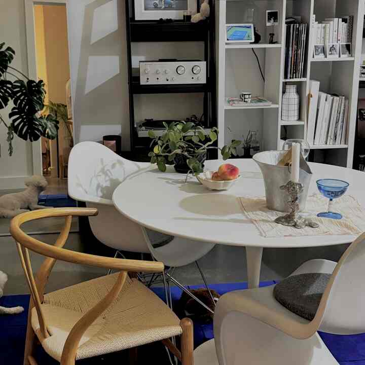 White and wood tone 4-person dining space with simple modern living room ambiance