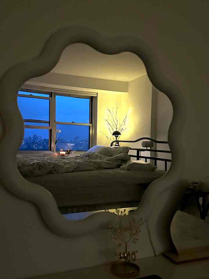 Ivory and natural-tone bedroom featuring a modern bed and soft warm lighting with cozy ambiance