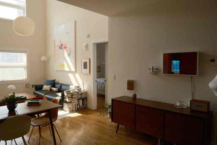 White and brown toned living room featuring sofa and sideboard with cozy atmosphere