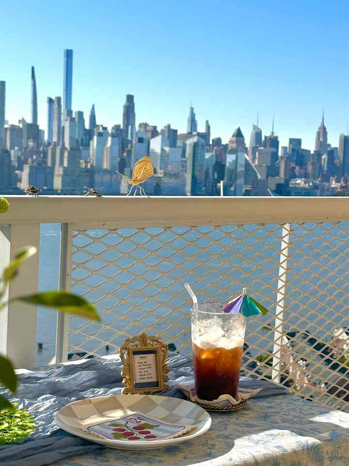Summer party at the balcony where the theme is a sit down home cafe. ☕️

A cute budget-friendly tip to a Summer home cafe party setup is to use little frames to place the menu of your home cafe available, place golden bees and butterflies on whimsical places, and to place a mini umbrella to your drinks. ⛱️

#summerparty #tablestyling #balcony #newyorkview #dopaminedecor 