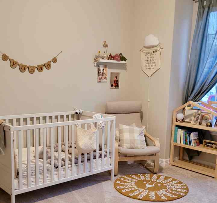 Beige tones and white kids' bed with a beige armchair in a cozy children's room interior