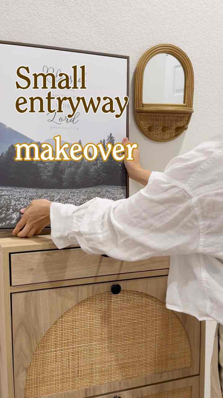 Beige and wood tone small entrance featuring rattan wall mirror and storage cabinet with natural cozy atmosphere