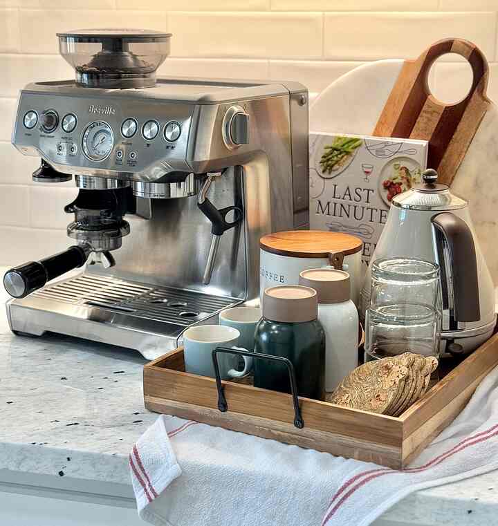 Natural tone kitchen home cafe with white tile wall and wooden coffee accessories on countertop