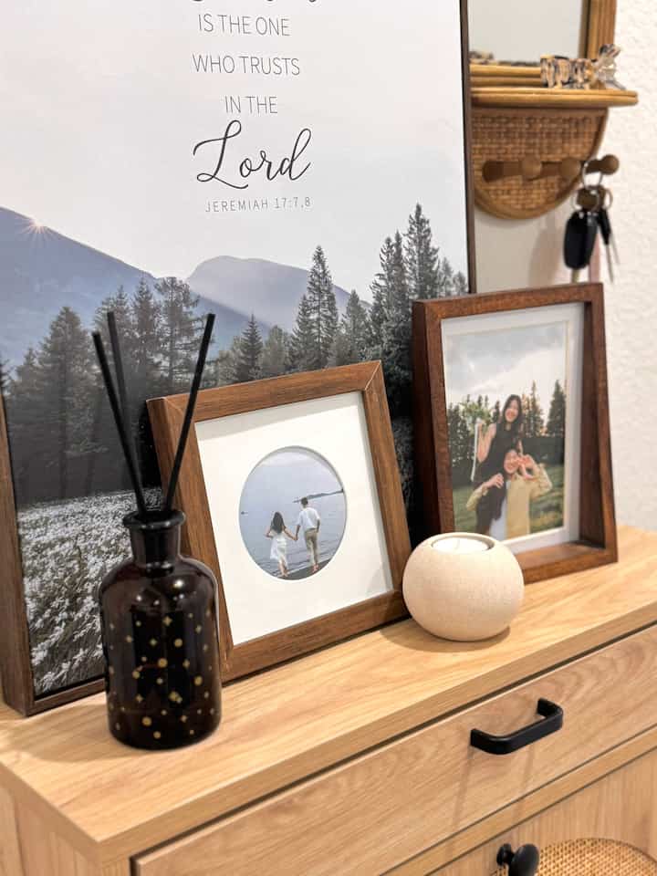 Beige and brown wood-tone entrance featuring wall decor and picture frames with a natural interior vibe