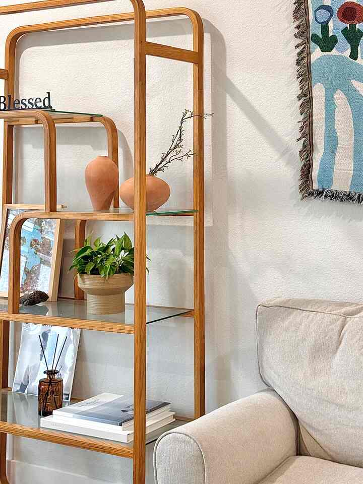 Natural wood tone living room with beige sofa, stylish objets and wall decor creating a cozy atmosphere