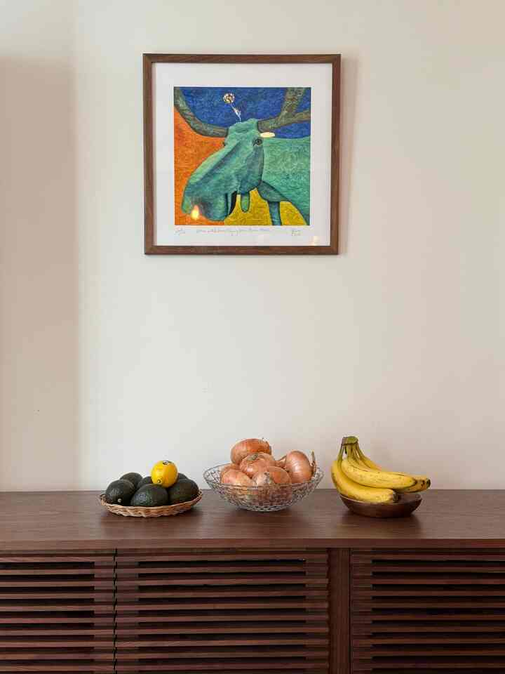 Natural tone kitchen space featuring wooden sideboard with bowls of fruit and onions in a minimalist arrangement