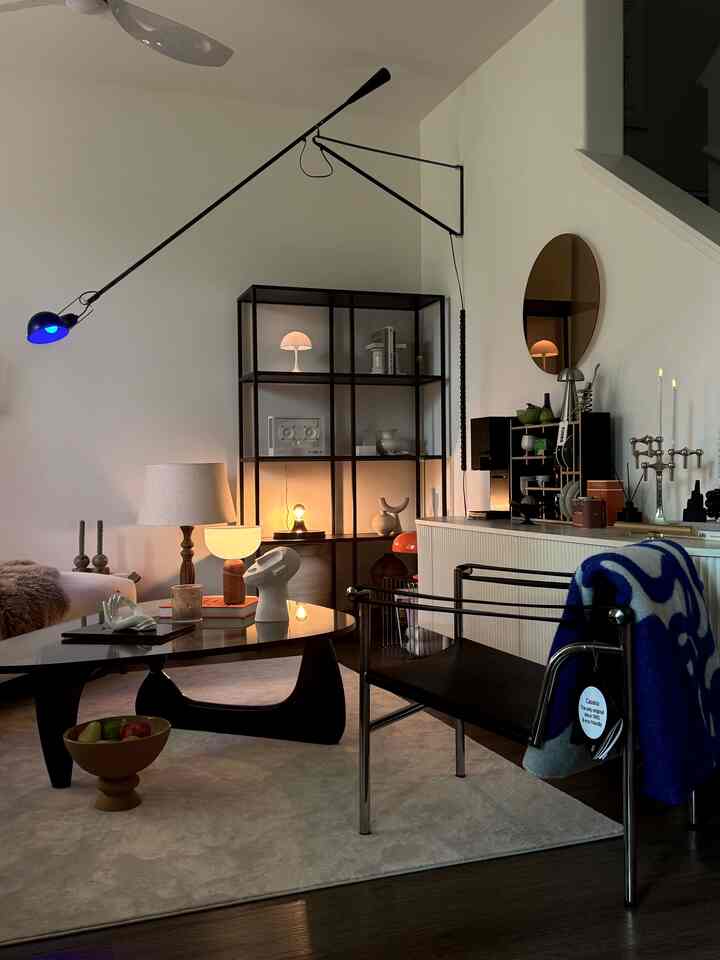 Natural beige-toned living room featuring mid-century modern furniture and varied ambient lighting for a cozy atmosphere