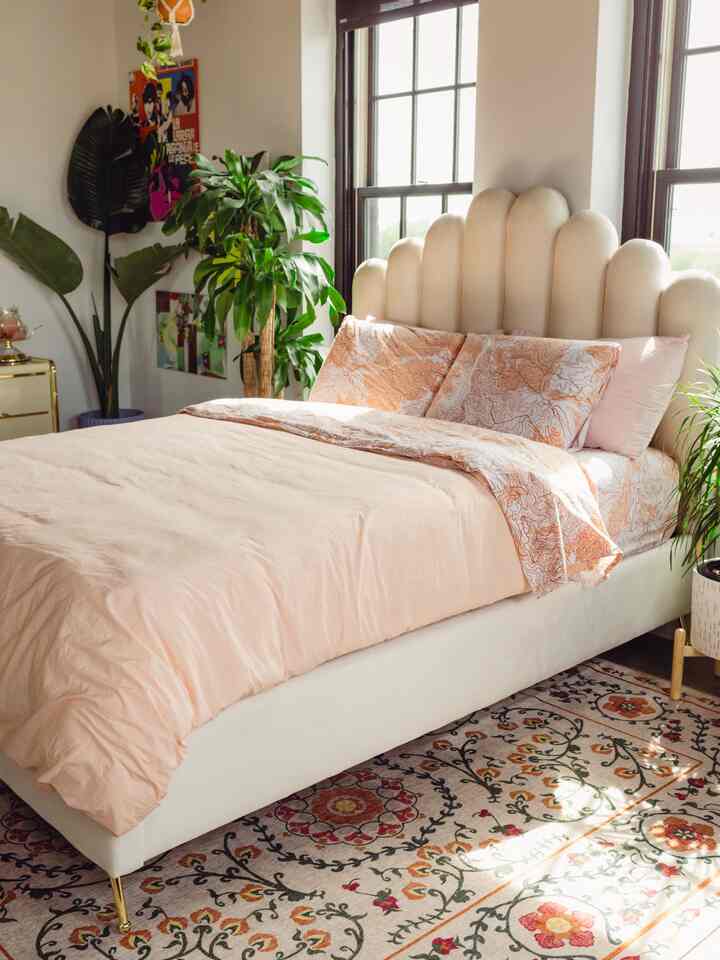 Golden hour light hitting my favorite spot! ☀️ That cloud-like scalloped headboard is giving total dreamy vibes. Paired with that beautiful patterned rug and all the lush greenery, this bedroom is my little sanctuary. 🌿💖😴
#BedroomGoals #ScallopedHeadboard #PeachAesthetics #Ruggable #PlantMama #BohoBedroom #InteriorInspo #GoldenHour #SweetDreams 

