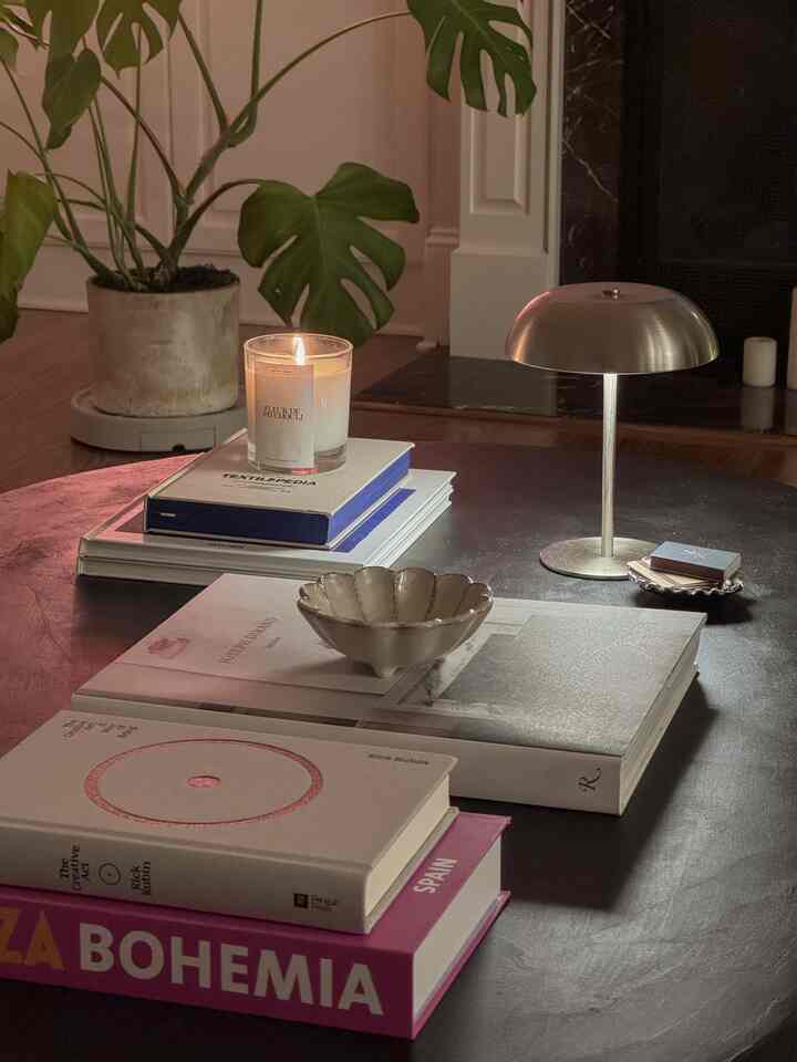 Current coffee table situation: 
.
.
.
#coffeetablesetup #candle #lamp #portablelamp #coffeetablebook #bowl #chromeaccents #ecclecticdecor #homedecor #moody #ambientlighting #cozycorner