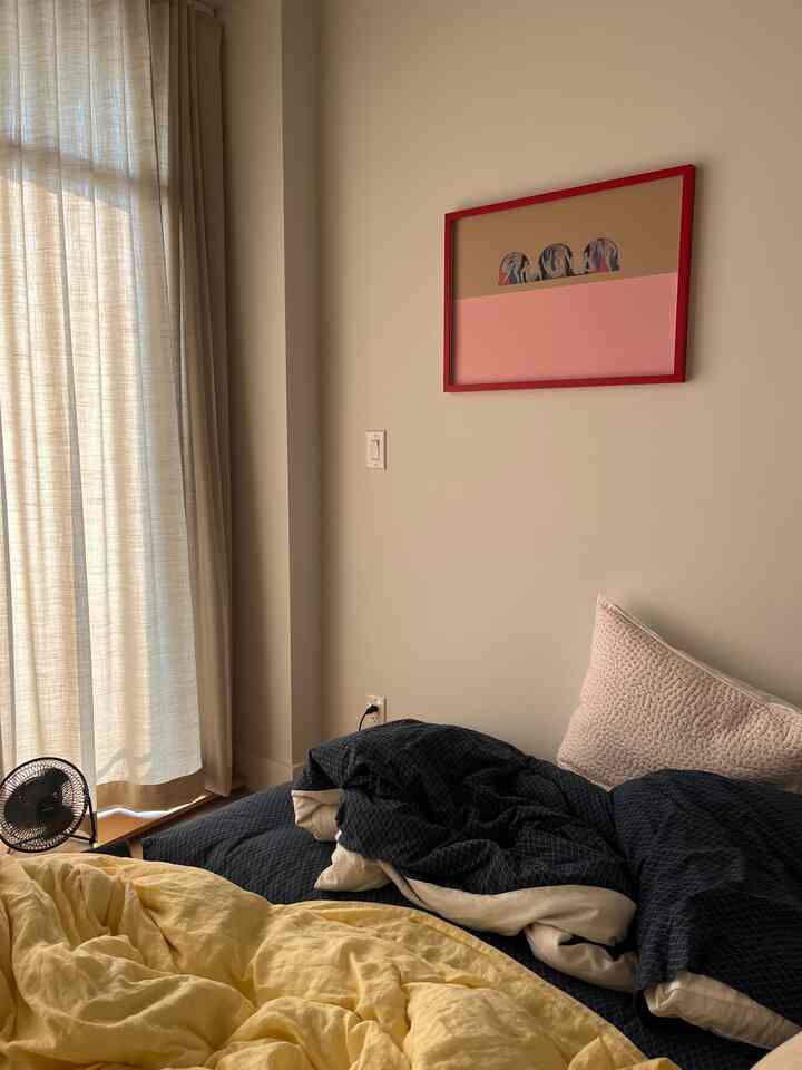 Natural-toned bedroom corner featuring blue and yellow bedding with a cozy atmosphere