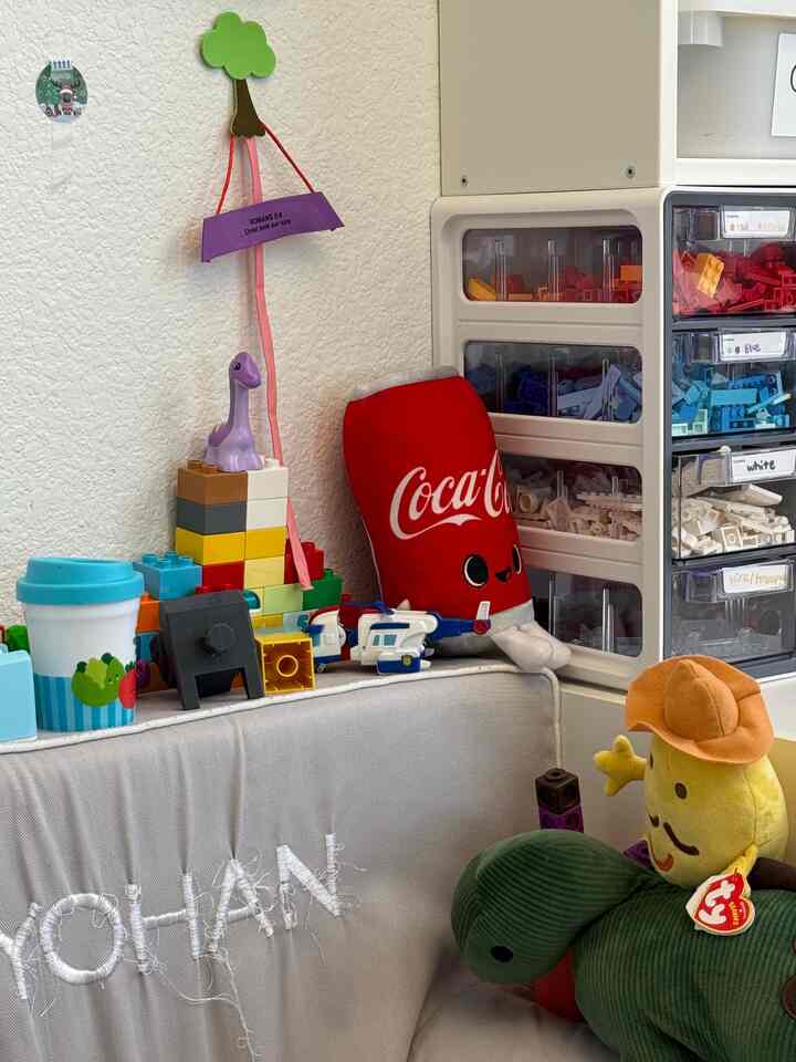 Natural color kids' room featuring toy storage organizers, a sofa, and a variety of colorful toys in a cluttered arrangement