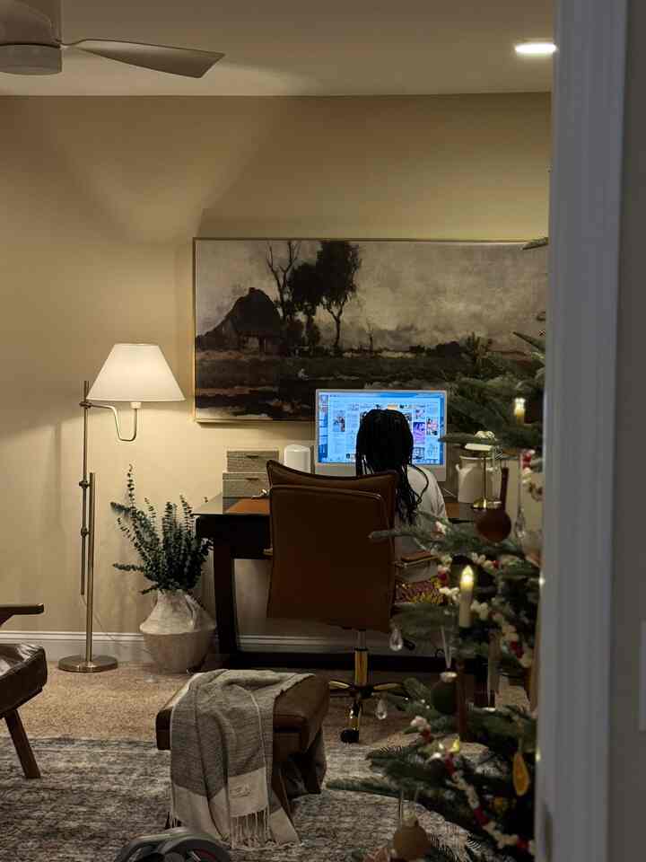 Beige-toned home office featuring a desk and brown office chair with warm lighting, creating a cozy and peaceful atmosphere