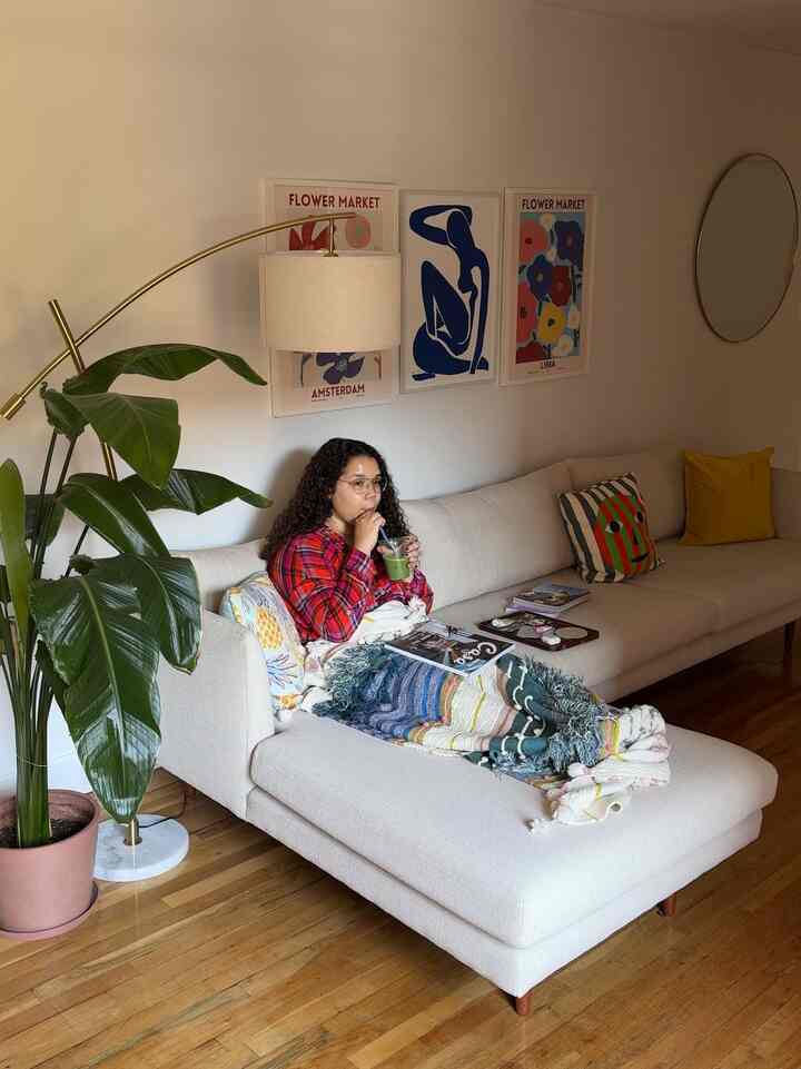 Natural-toned living room featuring a beige sofa with colorful throw and pillows creating a cozy atmosphere