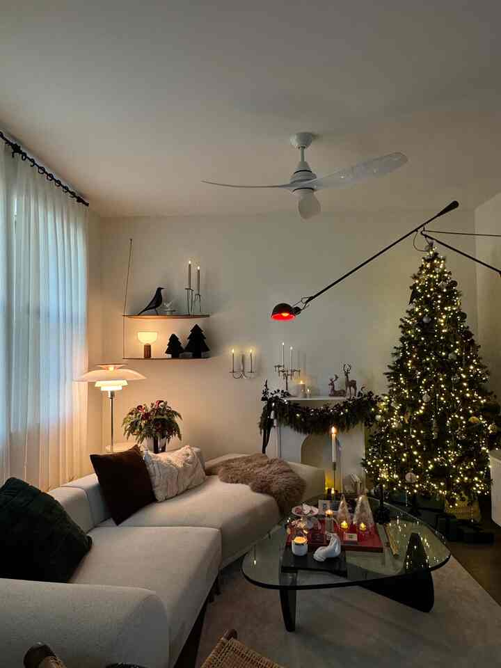 Ivory sofa and decorated Christmas tree in a warm, cozy living room interior