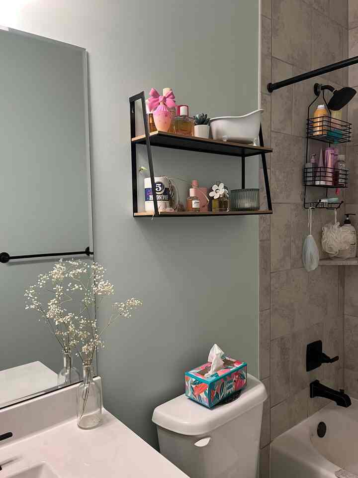 White and gray toned bathroom featuring wall shelves and bathtub with clean, practical interior design