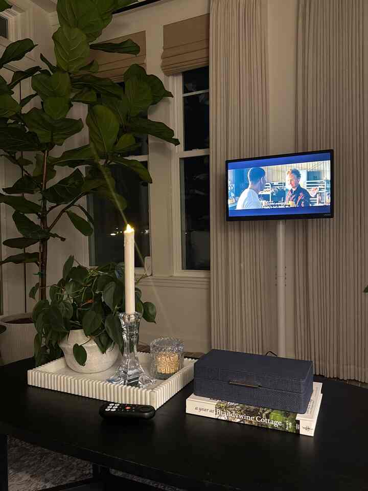 White walls and a black coffee table in a living room featuring a home cinema setup with a cozy atmosphere