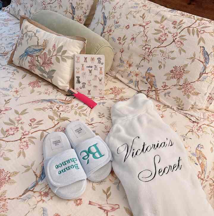 Soft ivory and floral-patterned living room sofa featuring a pet-themed notebook and cozy indoor slippers, creating a warm atmosphere