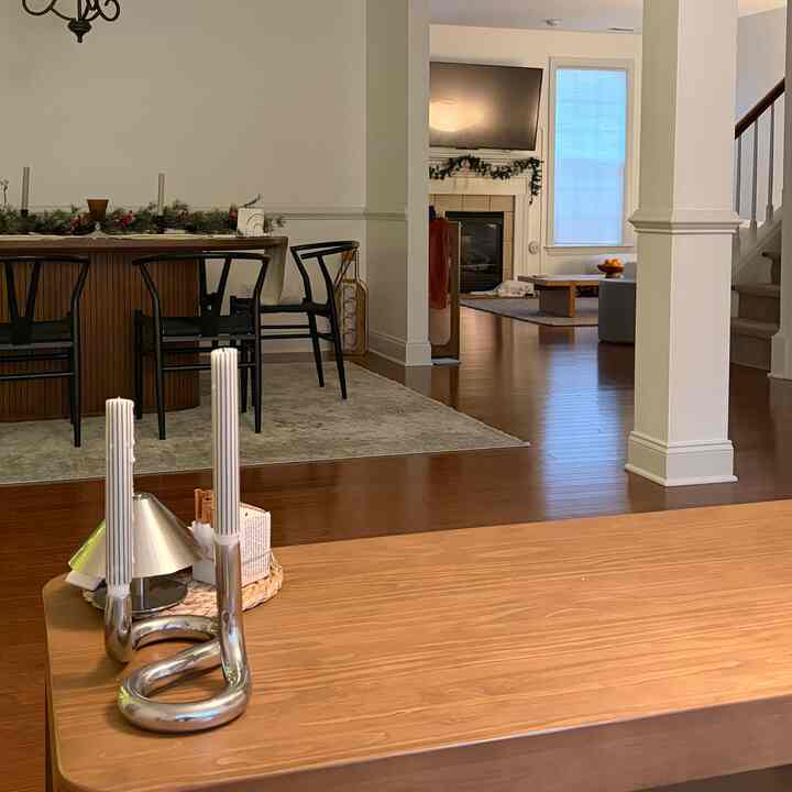 Natural wood tone and white walls define this open-plan living and dining room with a simple, natural modern feel