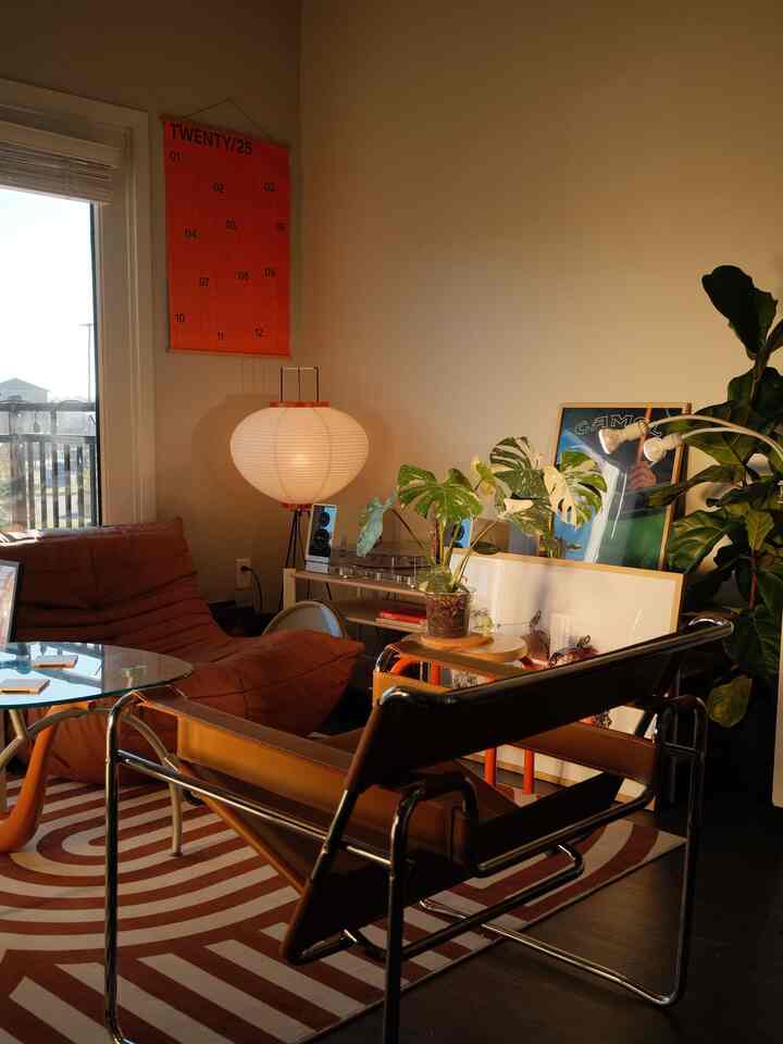 Warm brown-toned cozy living room featuring vintage chairs and green plants in harmony