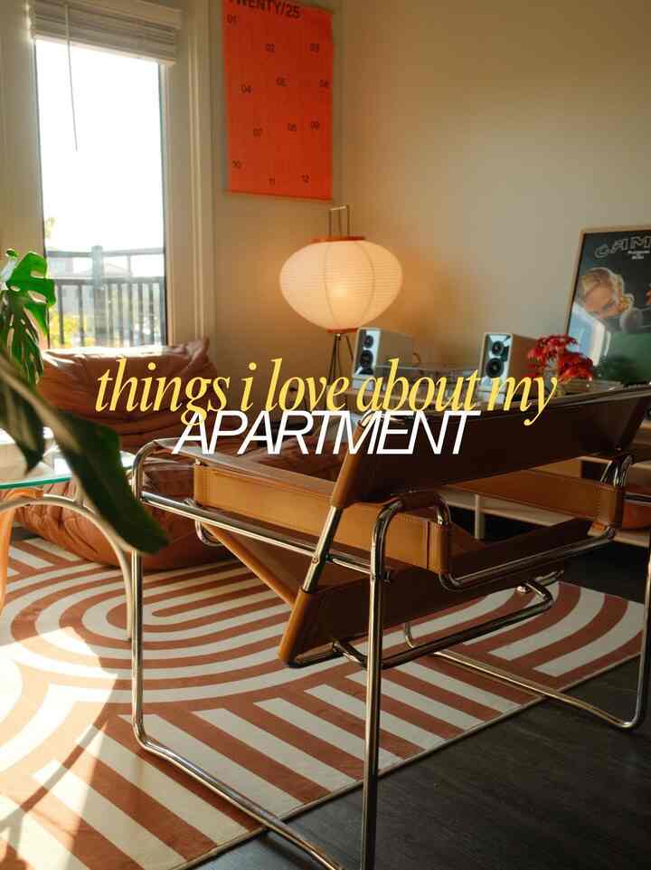 Natural brown-toned living room featuring a curvy striped rug and leather chairs in a modern setting