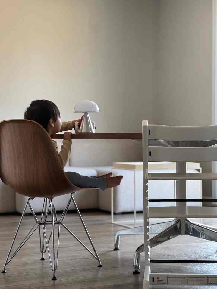 Natural-toned dining room featuring a baby and dining chairs with a calm, warm atmosphere