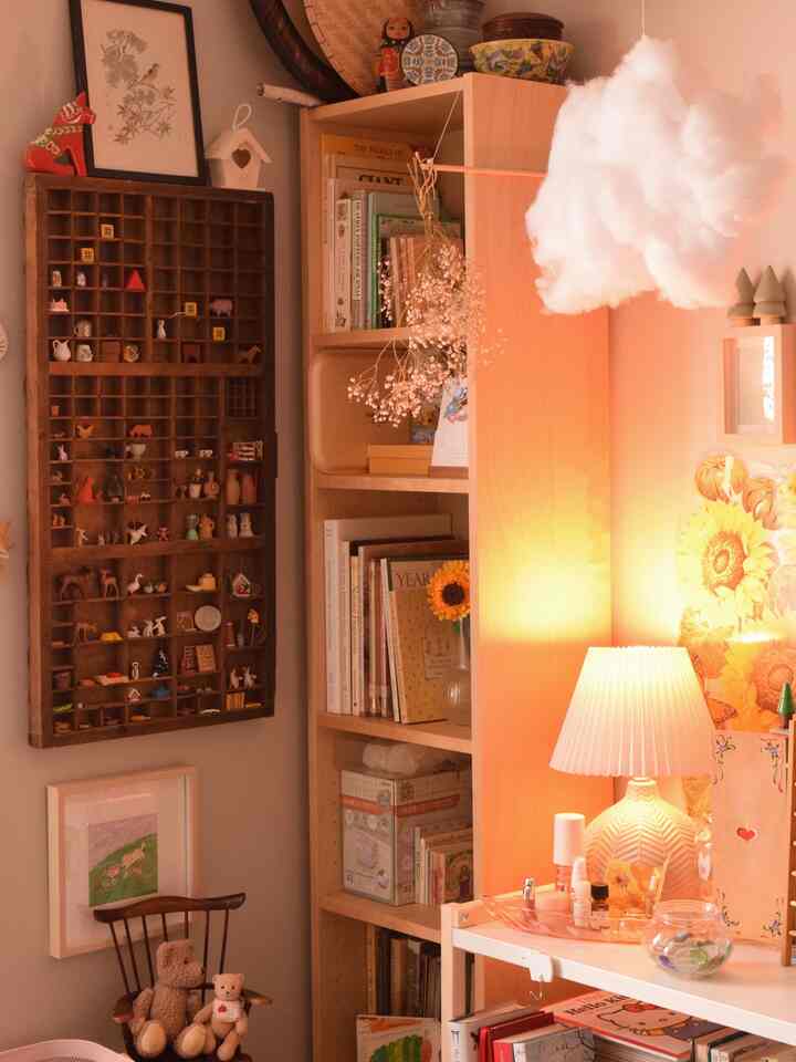 Warm natural color toned bedroom corner featuring vintage shelves and bookshelf adorned with charming trinkets creating cozy ambiance