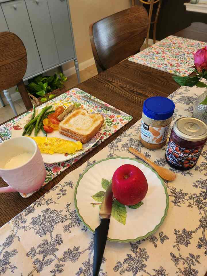 Brown wood dining table with vase and floral tablecloth in dining room space