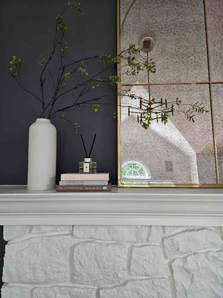 It's got all my favorite elements. White, Black, Green and Gold 🤍🖤💚💛
Everyone questioned about painting the fireplace in white. 
#livingroom #paintedfireplace #greens