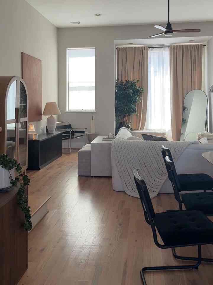 Warm beige and wood tone living room featuring Mid-Century Modern furniture and Japandi style, creating a cozy sanctuary