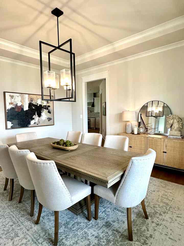 Beige and wood tone dining room featuring a large dining table and chairs in a cozy setting