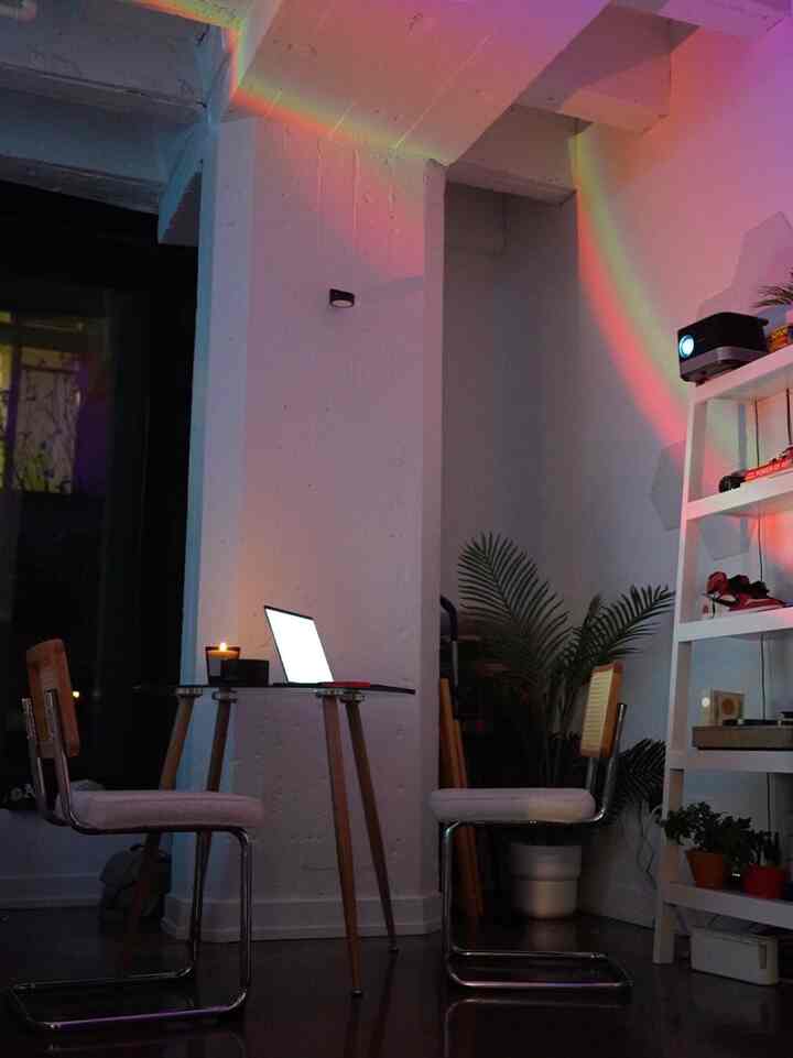 Calm white-toned Mid-Century Modern home office featuring natural wood elements and green plants, creating a serene workspace atmosphere