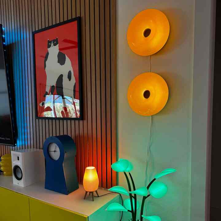Colorful living room featuring yellow wall sconces, blue clock, and green plant lamp creating a fun atmosphere