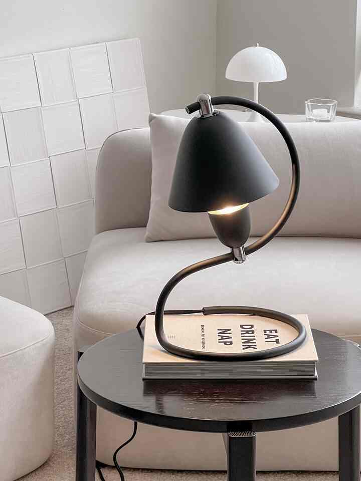 An easy way to add a touch of elegance for under 50 bucks.. A coffee table book! Just one can completely change the vibe of your space.

#black #blackinterior #beigeinterior #lightingstand #livingroominterior #livingroomtable #livingroomdecoration 